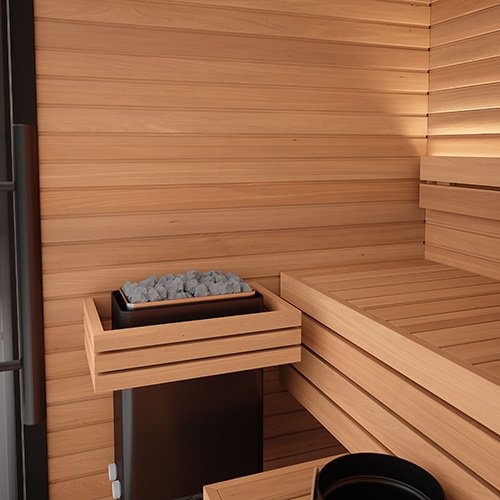 Wooden sauna interior with a bench and sauna heater.