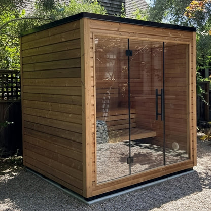 An outdoor traditional luxury sauna with a premium style door and full tempered glass front wall, featuring a black finish and wood details.