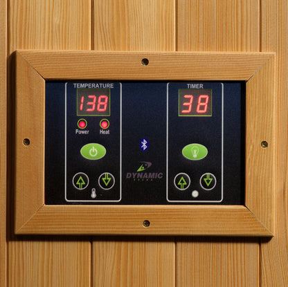 Digital sauna control panel with temperature and timer display on a wooden background