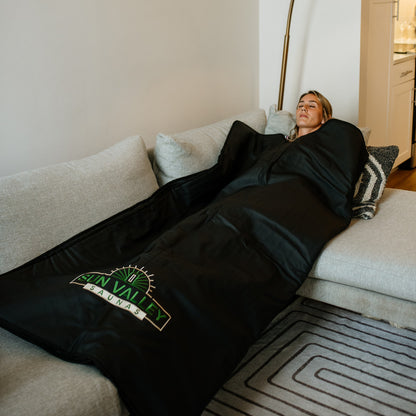 Woman using Sun Valley Saunas Infrared Sauna Blanket