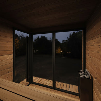 Wooden sauna with glass doors at night