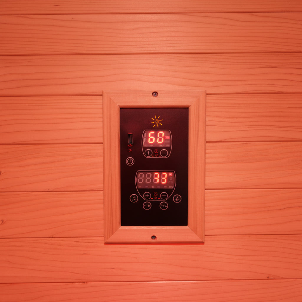 Wooden sauna wall with digital control panel displaying temperature and time.