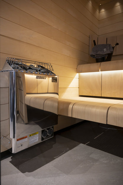 Harvia Kip wall-mounted sauna heater beside the benches