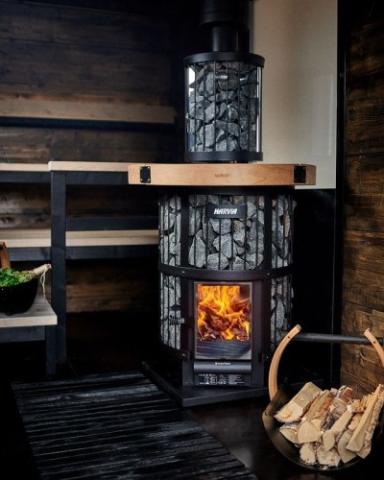 Harvia Legend 240 GreenFlame installed in a dark wood sauna