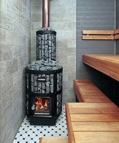Harvia Legend sauna stove with chimney stone basket in a tiled sauna