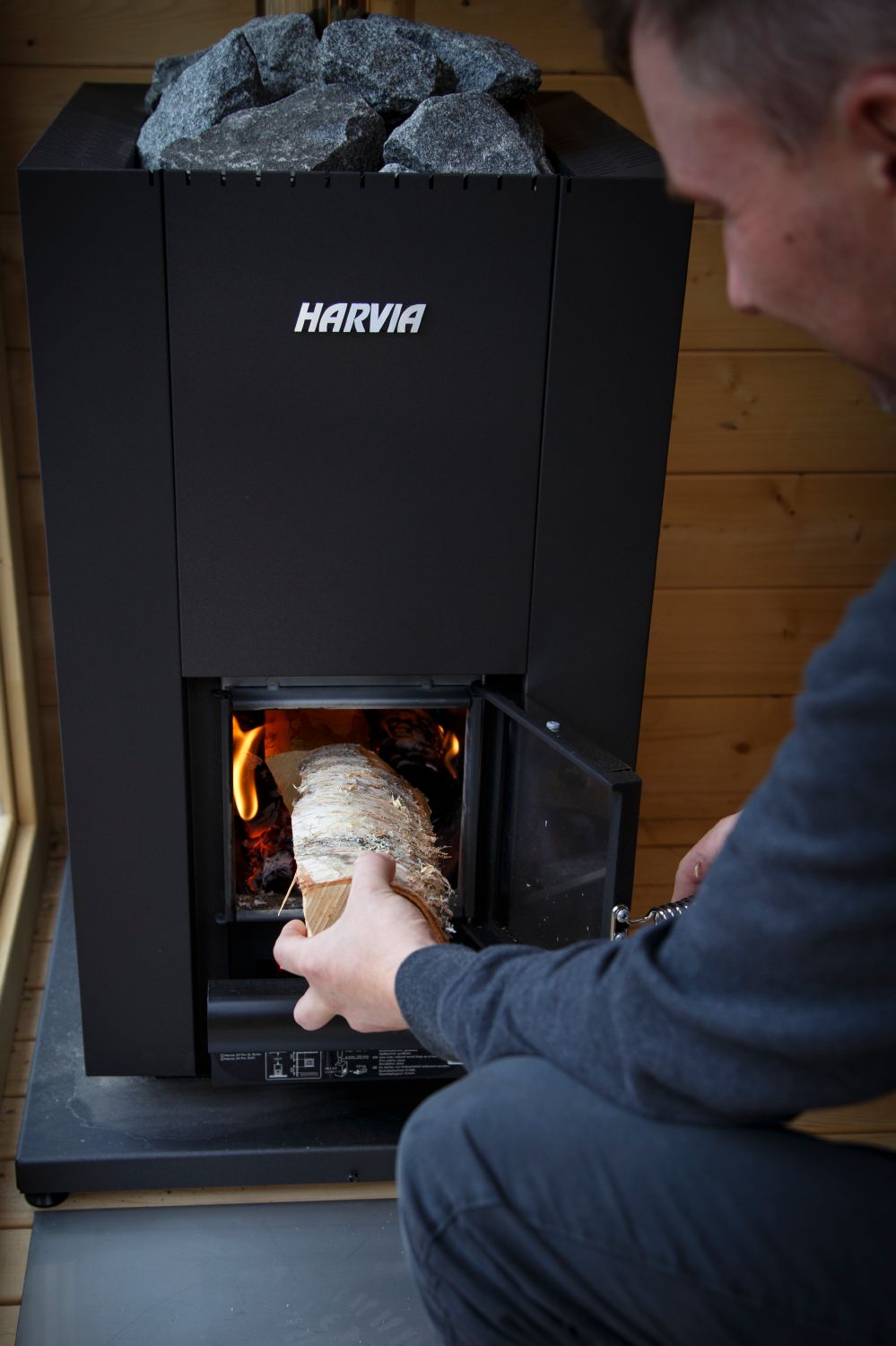 Loading firewood into the Harvia Linear 18 Compact