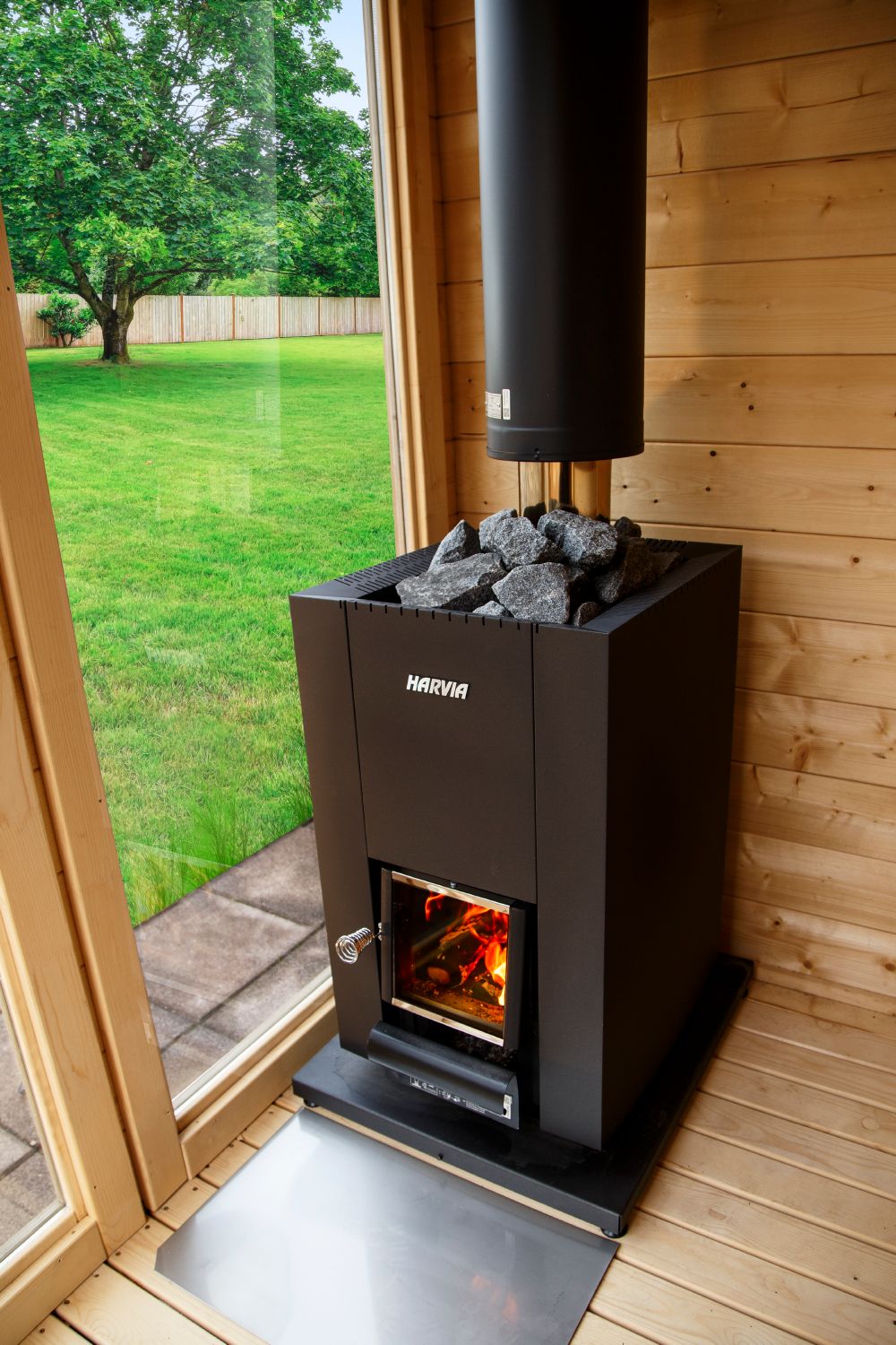 Harvia Linear 18 Compact in an outdoor sauna with a garden view