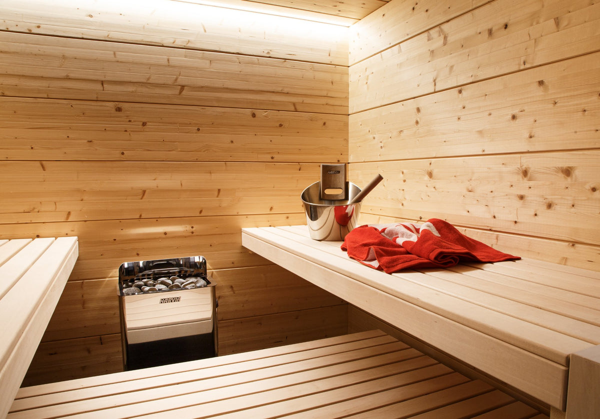 Harvia The Wall heater in a home sauna with wood benches