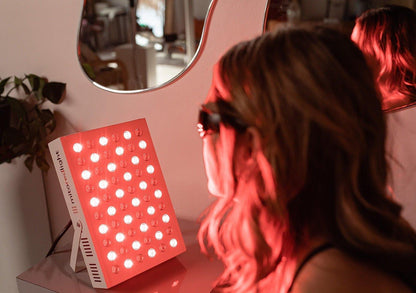 Woman using Red Light Therapy Panel