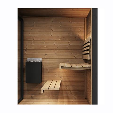 Interior of wooden sauna with benches and a black heater.